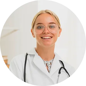 Natalie Brown, smiling, in a white coat with a stethoscope